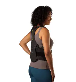 A woman wearing a back brace for her shoulder.